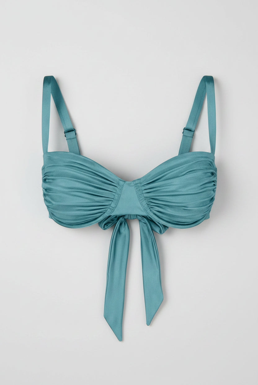 Teal bikini top with a bow detail on a white background