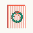 Greeting card with a Christmas wreath and bow on a striped background