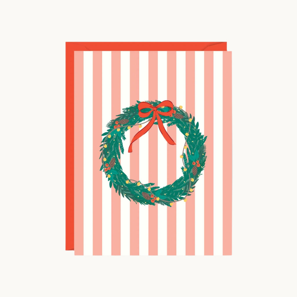 Greeting card with a Christmas wreath and bow on a striped background