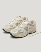 Pair of beige sneakers on a white background