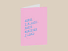 Pink greeting card with blue text on a white background