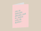 Pink greeting card with green text on a white background